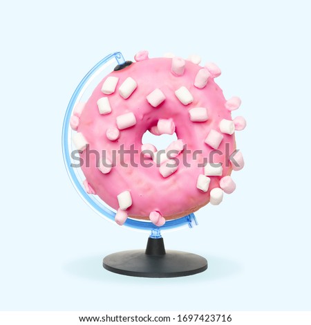 Pink sugarred donut with marshmallow as a globe on blue background. Negative space to insert your text. Modern creative design. Contemporary colorful and conceptual bright art collage with food