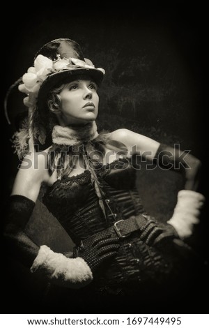 Old-fashioned black and white portrait of a young cabaret showgirl in her stage costume