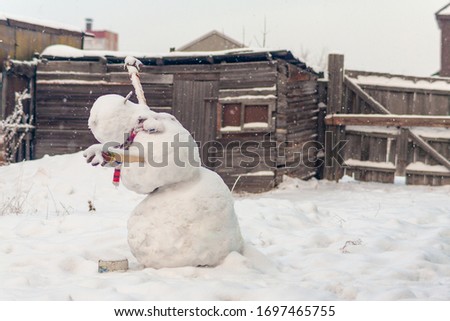Snowman rejoices in falling snow