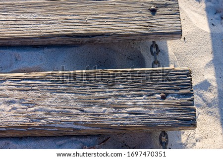 Chained planks for a boardwalk on to the beach
