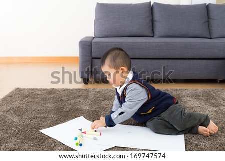 Asian baby boy drawing at home