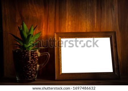 Isolate picture frame on table and coffee bean in glass.
