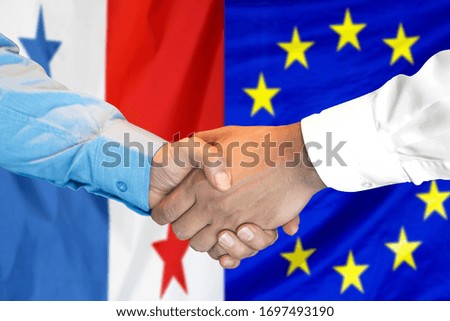 Business handshake on the background of two flags. Men handshake on the background of the Panama and European Union flag. Support concept
