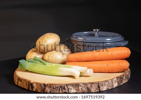 Stock pot on a board with ingredients
