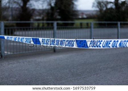 Police barrier tape in the UK at the scene of a crime
