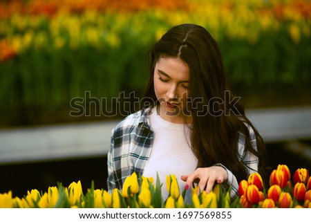 Beautiful young smiling girl with tablet, worker with flowers in greenhouse. Concept work in the greenhouse, flowers. Copy space – stock image