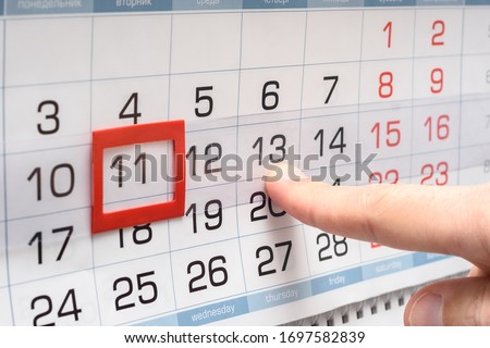 The finger points to the future Thursday on the calendar Royalty-Free Stock Photo #1697582839