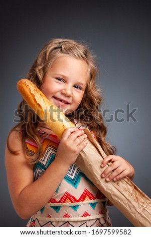 young emotional girl holding a baguette
