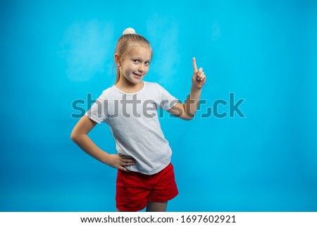 a schoolgirl stands on a blue background 