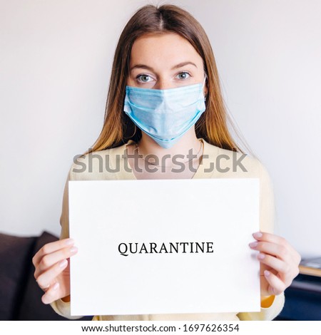 woman wearing medical hold paper with the word "quarantine". Self-isolation concept.