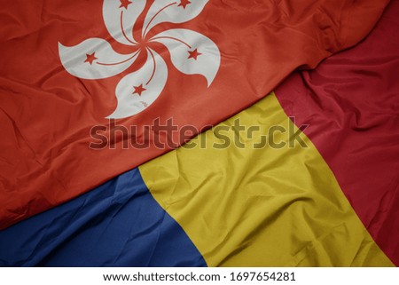 waving colorful flag of romania and national flag of hong kong. macro