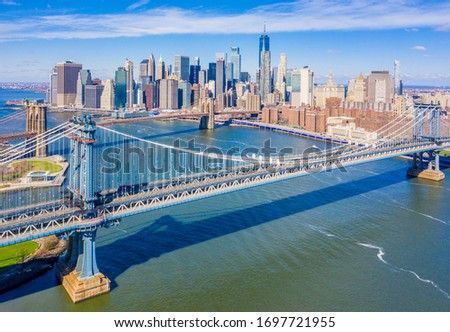 Aerial view of the Manhattan Bridge and Brooklyn Bridge along the East River with the New York City skyline from DUMBO