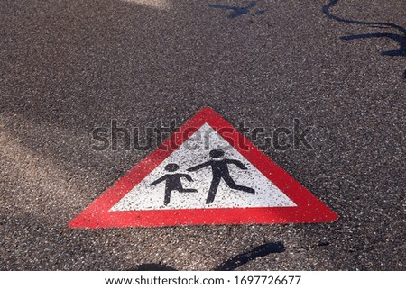 Children on the road, sign painted on the asphalt