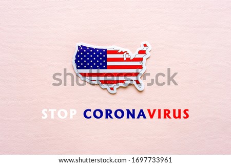 Stop coronavirus in USA. Map of United States of America with american flag on light paper background. Text STOP CORONAVIRUS. Covid-19 outbreak, pandemic concept