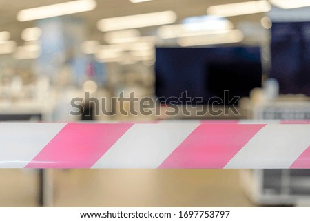 Closed appliance store with security tape in the foreground.