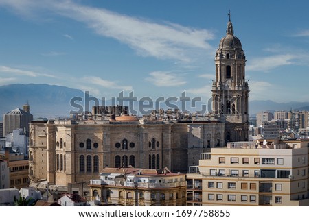 The Malaga Cathedral La Manquita outside panoramic view with tower bell and roof in Malaga.