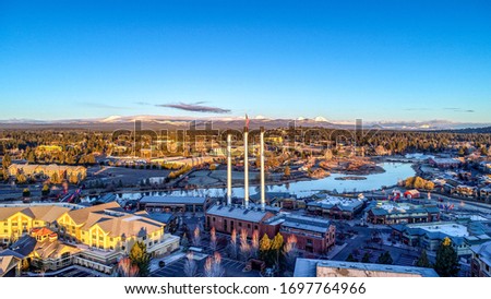 Old Mill Smokestacks at Sunrise on the Deschutes River in Bend, Oregon Royalty-Free Stock Photo #1697764966