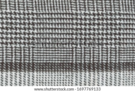Texture of natural wool fabric in a small cage with stripes. Background of rough warm fabric.