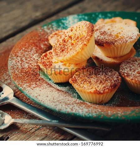 Lemon Tartlets decorated with Powdered sugar and cocoa, toned picture