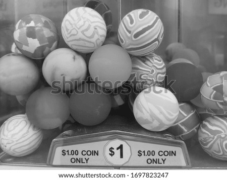 Monochrome picture of vending machine showing several small prize balls