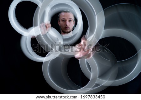 Abstract image of juggler with smoothed rings isolated on black background 