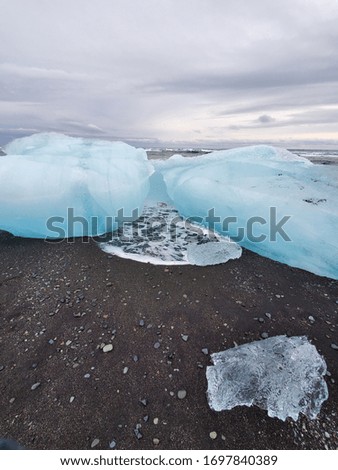 Black sand beach with icebergs