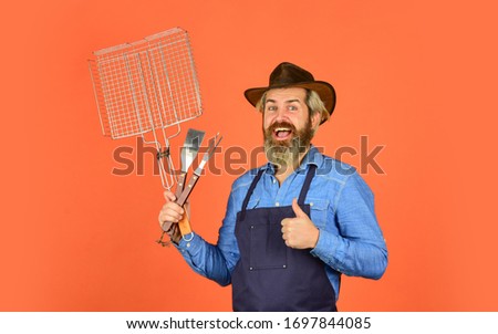 Culinary concept. summer weekend. happy hipster hold cooking utensils for barbecue. bearded man chef. Tools for roasting meat outdoors. Picnic and barbecue. ready for barbecue party.