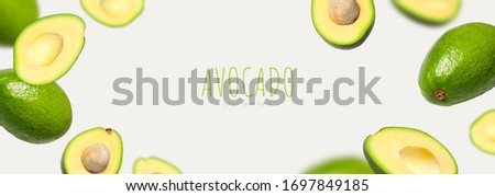 Creative layout with ripe flying avocado halves on light background. Healthy food, diet, tropical exotic fruit, trendy food product. Minimalistic summer food concept. Organic avocado. Pop art design