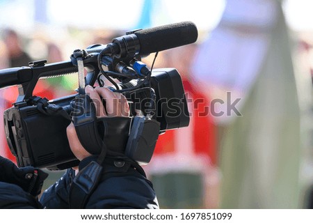 videographer shoots a report on a professional video camera