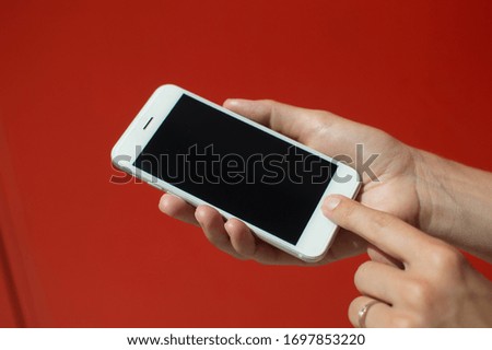 Female holding touch screen mobile phone, closeup