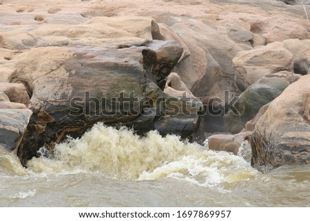 waterfalls under rocks heading into underground cascade