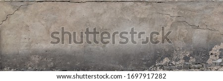 A gray plastered wall with a crumbling dirty texture Royalty-Free Stock Photo #1697917282