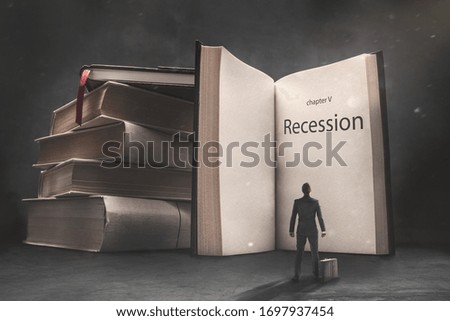 Abstract vision of a businessman standing in front of a huge book with "recession" inscription. Conception of recession in business.