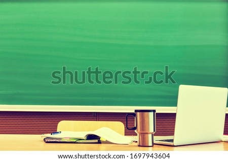 Green Chalk board in a college school or university with the text in chalk saying