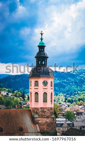 Collegiate church Stiftskirche and cityscape with Black forest in Old city Baden in Wurttemberg region in Germany. View of Bath and spa German town in Europe. Landmark scenery