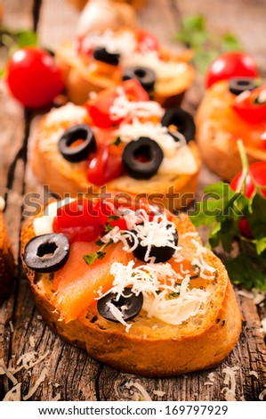 Bruschetta with salmon and feta cheese.Selective focus on the front bruschetta