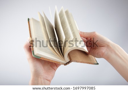 Woman browsing old book on white background