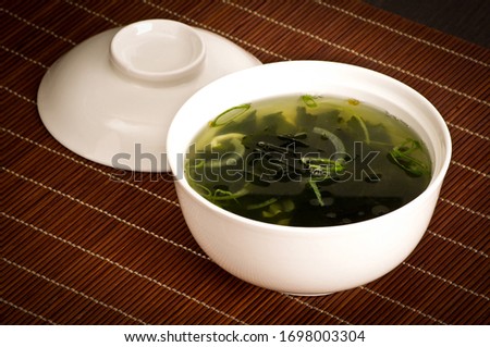 Green herbs soup in the bowl. Chinese cuisine