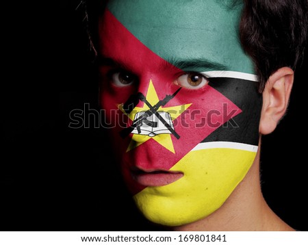 Flag of Mozambique Painted on a Face of a Young Man