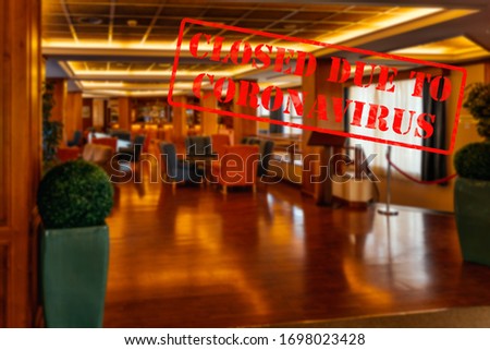 Defocused, blurred view of interior of traditional bar or restaurant, empty and closed due to coronavirus or covid 19 pandemics