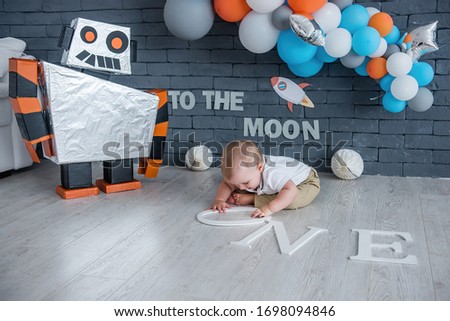 The baby celebrates his first birthday in a space set.