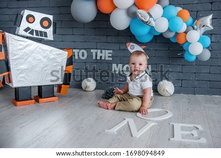 The baby celebrates his first birthday in a space set.