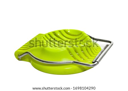 Green egg slicer isolated on white background