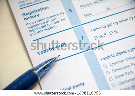 Closeup of voter registration form, Vote-by-Mail section, with a pencil on top Royalty-Free Stock Photo #1698110953