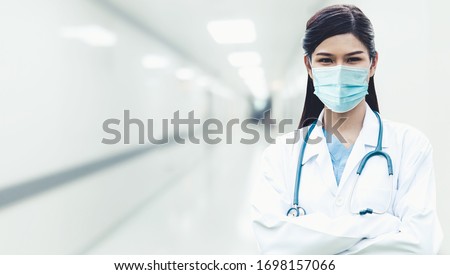 Doctor at hospital wearing medical mask to protect against coronavirus 2019 disease or COVID-19 global outbreak. Royalty-Free Stock Photo #1698157066