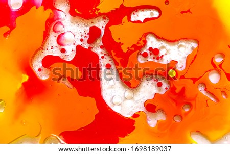 Orange watercolor ink in water with oil. Futuristic trend background. Planets, the universe and space. Cool trending screensaver. Abstract background.
