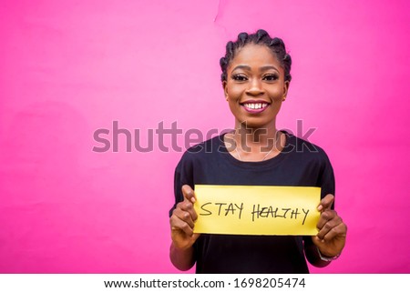 young black African woman holding a placard a Stay healthy  creating awareness  