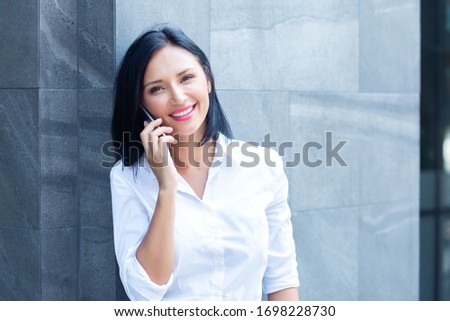 Young woman using smartphone work office outside, copy space.