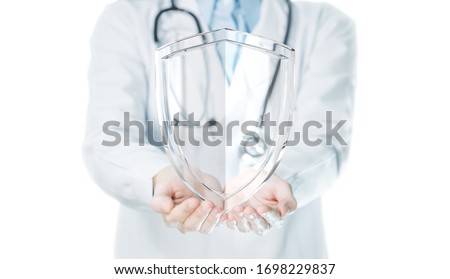 Doctor hands holding shield on white background for medical protection concept. Royalty-Free Stock Photo #1698229837