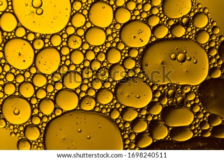Abstract Yellow water bubbles background. Macro shot . Oil bubbles close up 